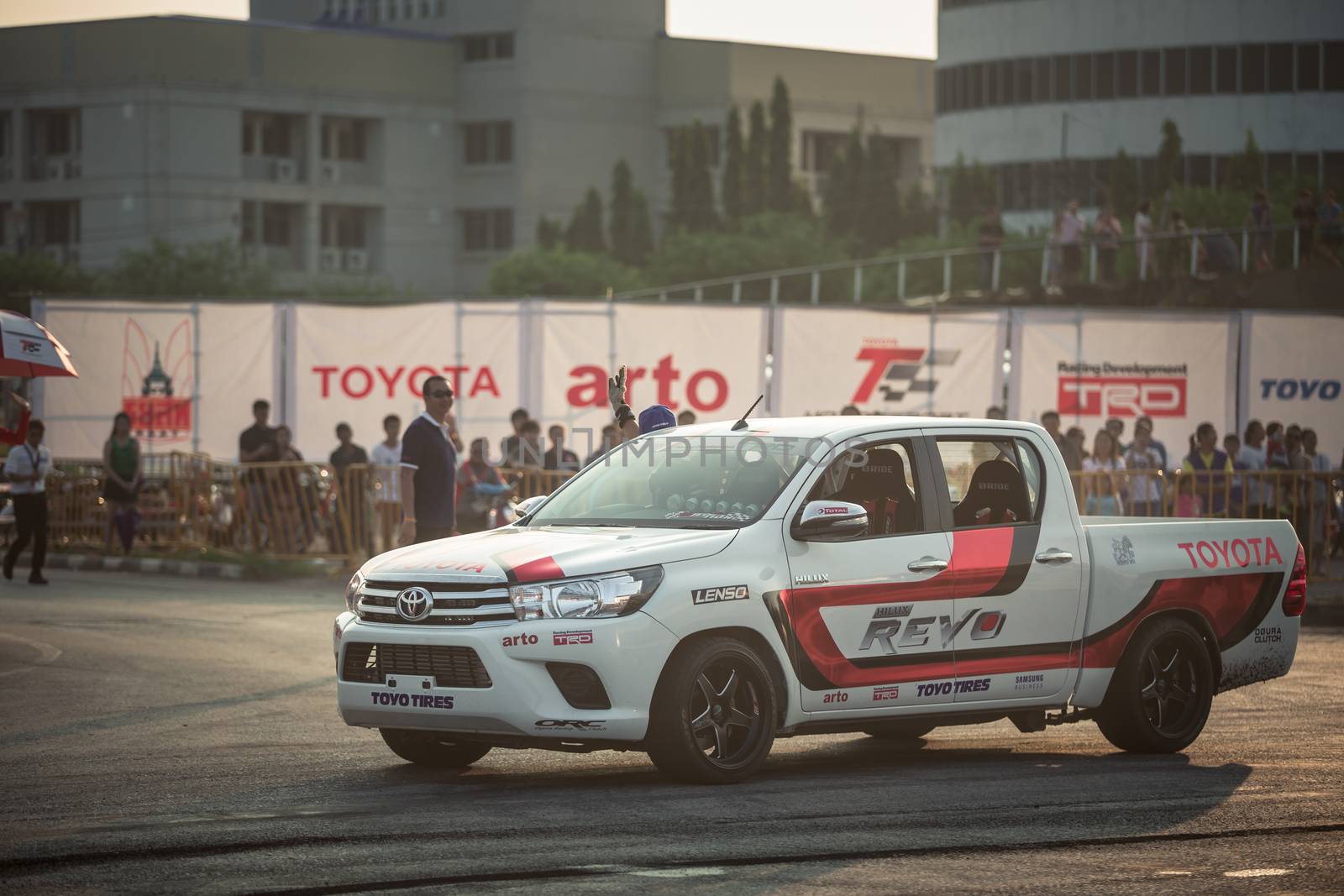 Udon Thani, Thailand - October 18, 2015: Techapol Toyingchareon the driver of Toyota Hilux Revo waving hand to the audiences after drifting contest on the track between driver from Thailand and Japan at the event Toyota Motor Sport show at Udon Thani, Thailand