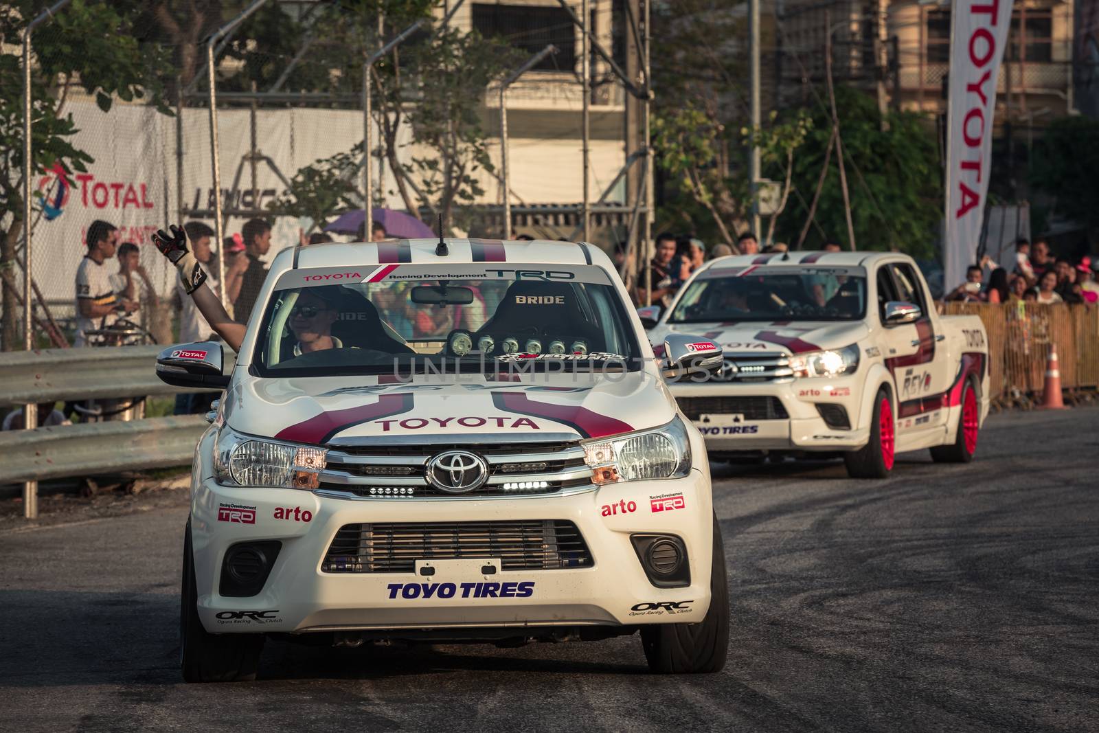 Udon Thani, Thailand - October 18, 2015: Techapol Toyingchareon the driver of Toyota Hilux Revo waving hand to the audiences after drifting contest on the track between driver from Thailand and Japan at the event Toyota Motor Sport show at Udon Thani, Thailand