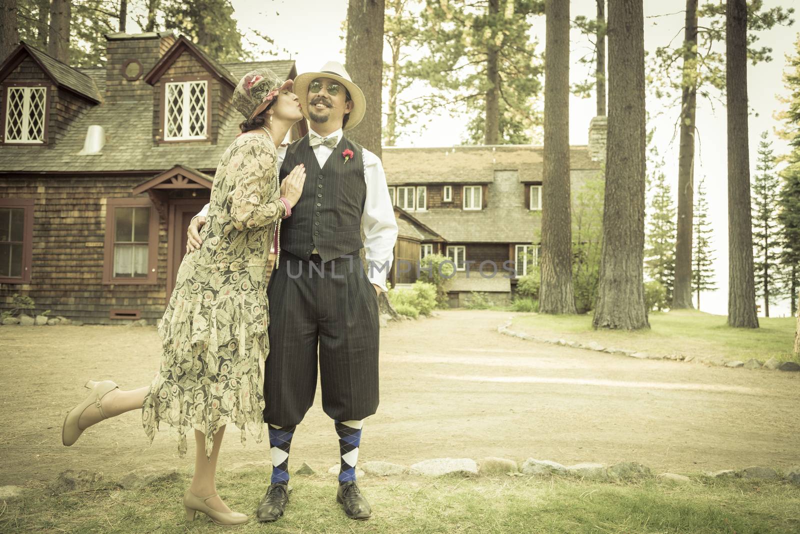 1920s Dressed Romantic Couple in Front of Old Cabin by Feverpitched