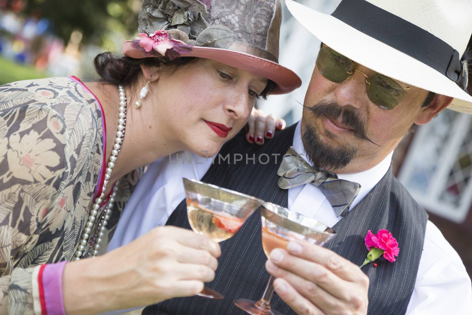Mixed-Race Couple Dressed in 1920’s Era Fashion Sipping Champa by Feverpitched