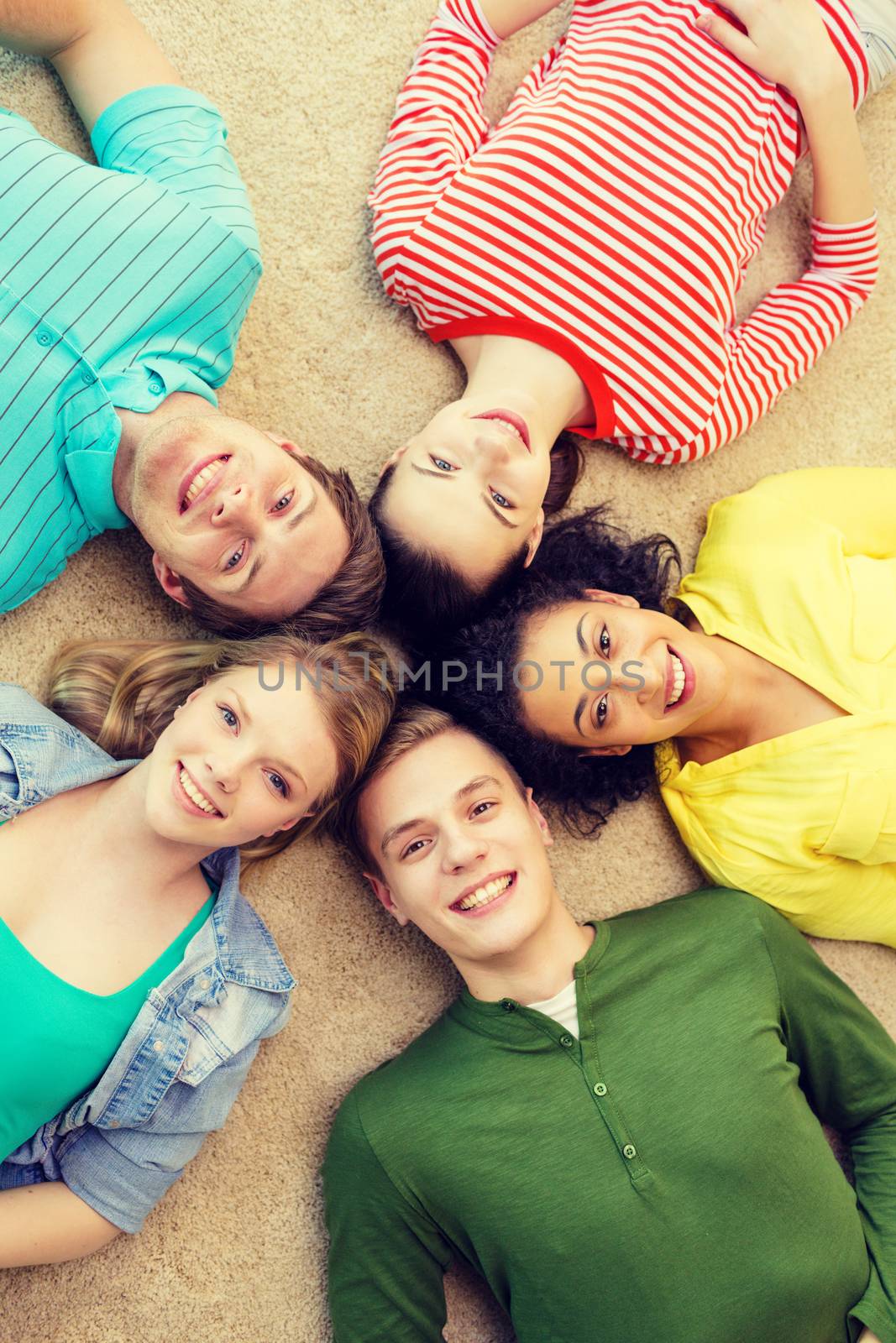 group of smiling people lying down on floor by dolgachov