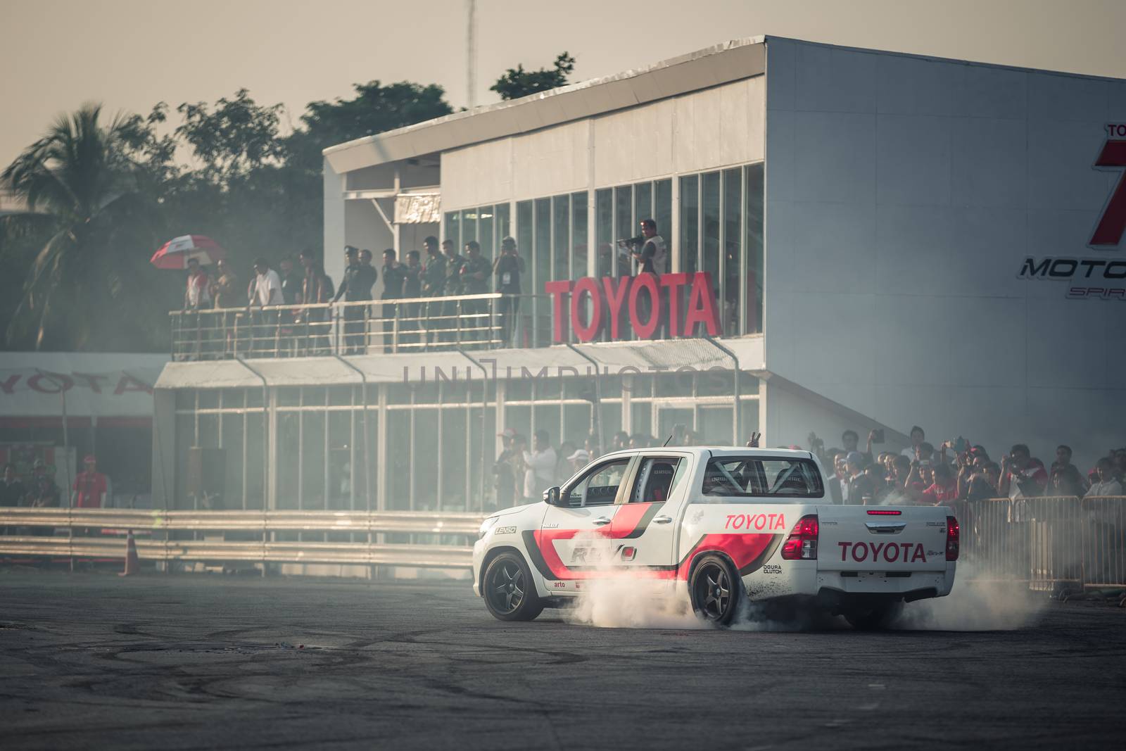 Pick-up car perform burnout tire on the track  by aotweerawit