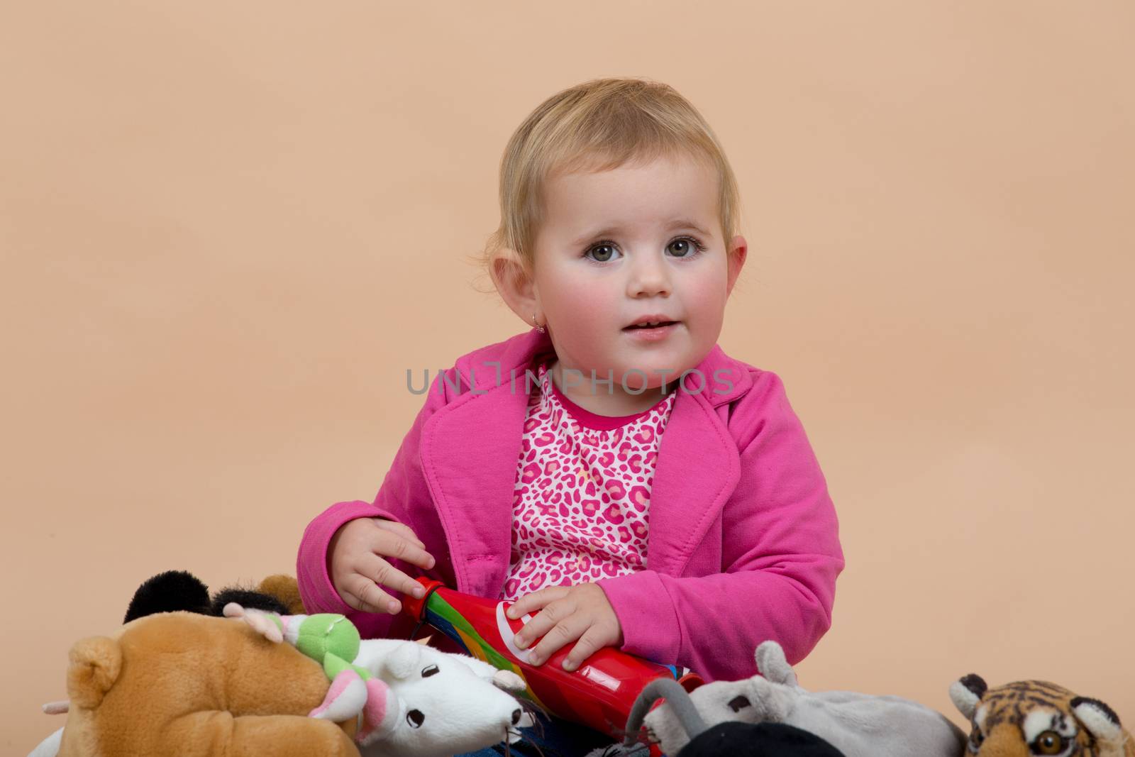 portrait of young cute baby on beige background