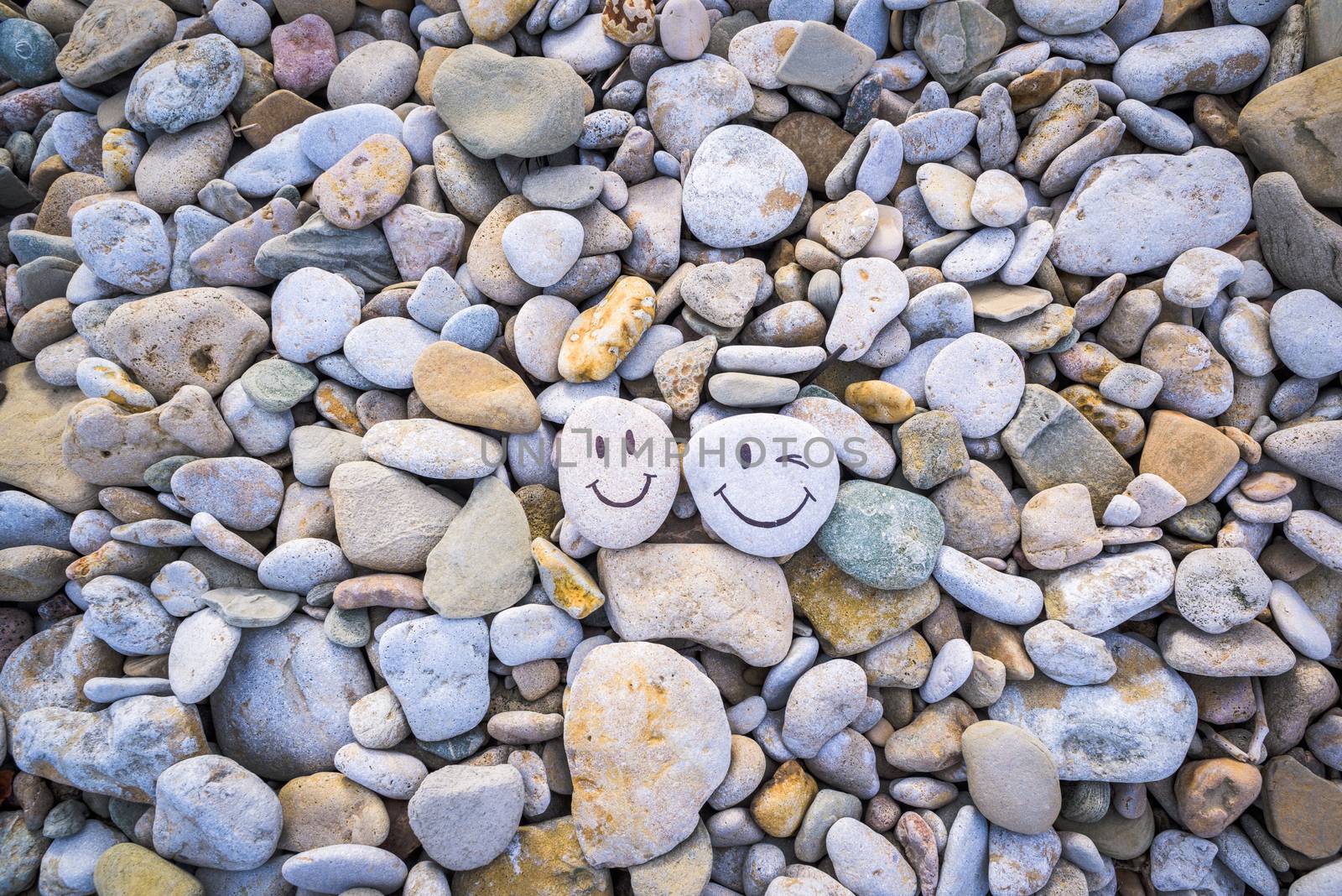 Emoticons on pebbles on the seashore