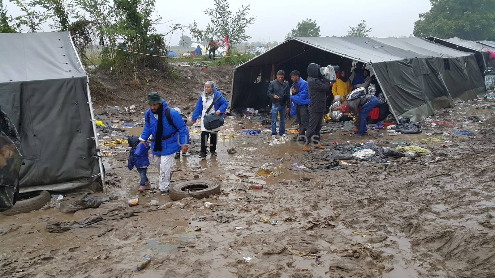 SERBIA, Sid: Refugees gather at a camp in Sid, Serbia on October 19, 2015, where they have been stranded in the cold for nearly two days before the opening of the border with Croatia that day. The area has become increasingly congested with refugees since the weekend, when Hungary closed its borders with Croatia.