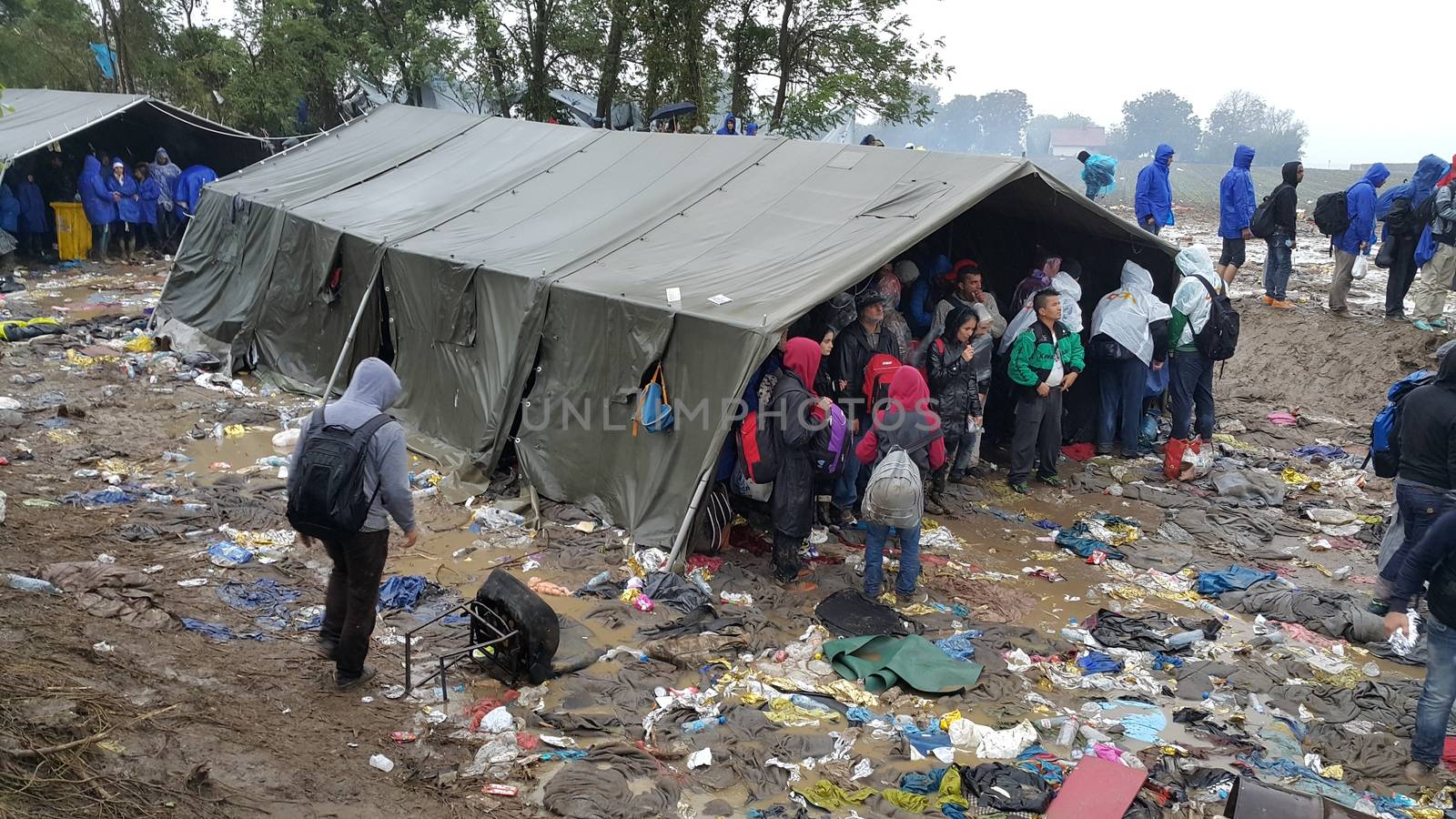 SERBIA, Sid: Refugees gather at a camp in Sid, Serbia on October 19, 2015, where they have been stranded in the cold for nearly two days before the opening of the border with Croatia that day. The area has become increasingly congested with refugees since the weekend, when Hungary closed its borders with Croatia.