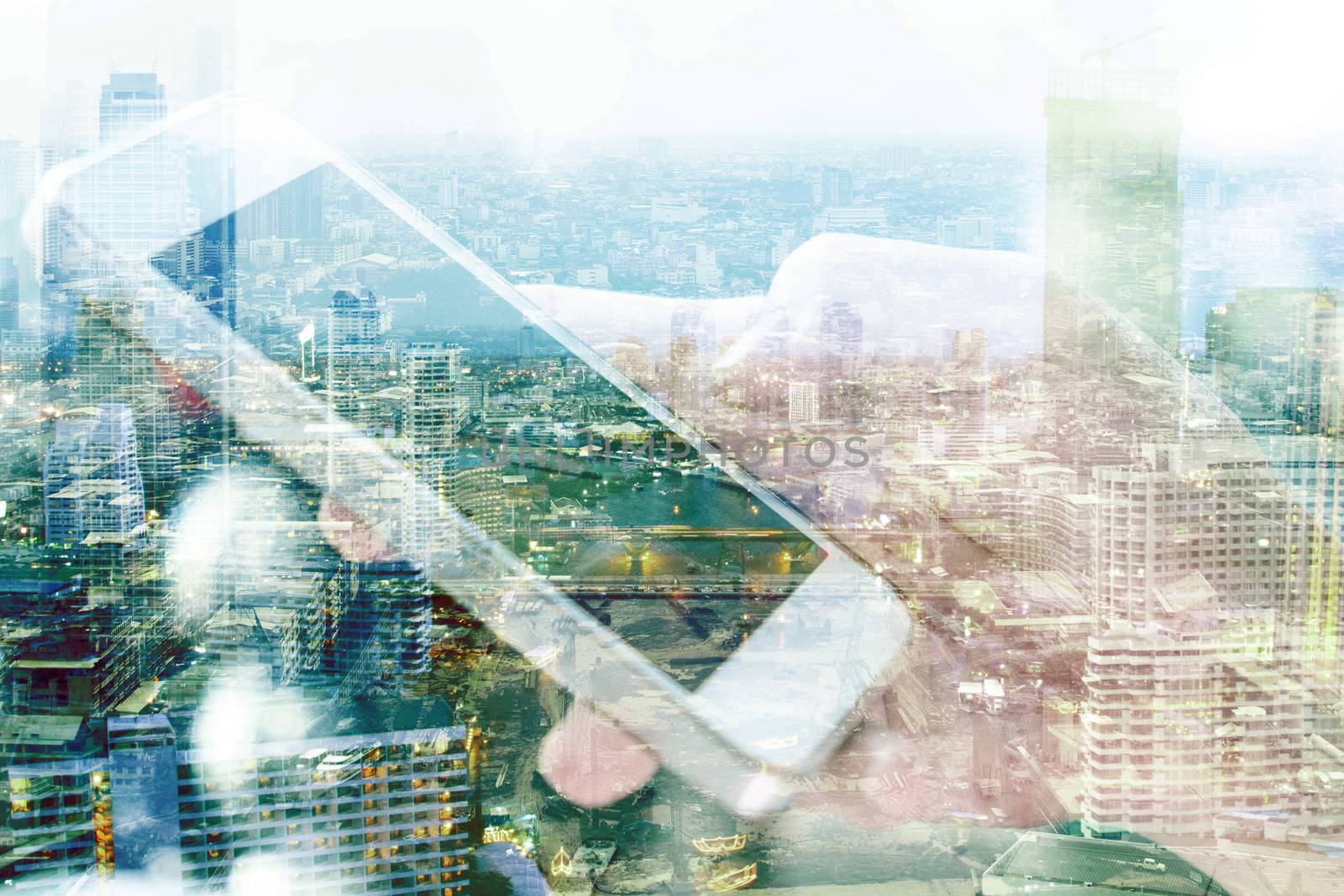 Double exposure of smart phone and cityscape background, communication technology concept