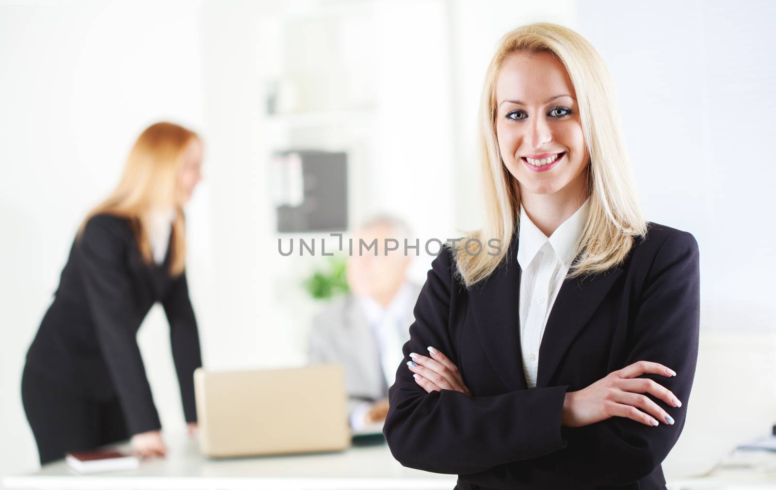 Beautiful young businesswoman in the office. Looking at camera. Selective Focus.