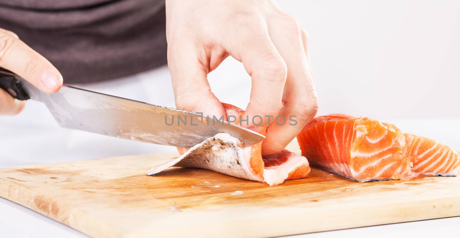 Preparing salmon in the cutting board.