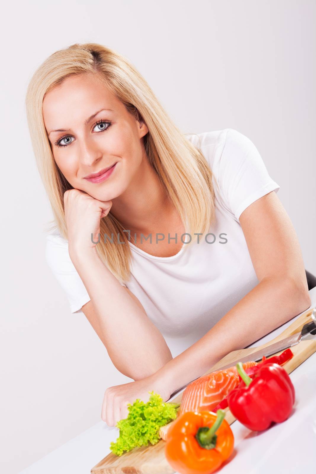 Happy young beautiful woman in the kitchen.