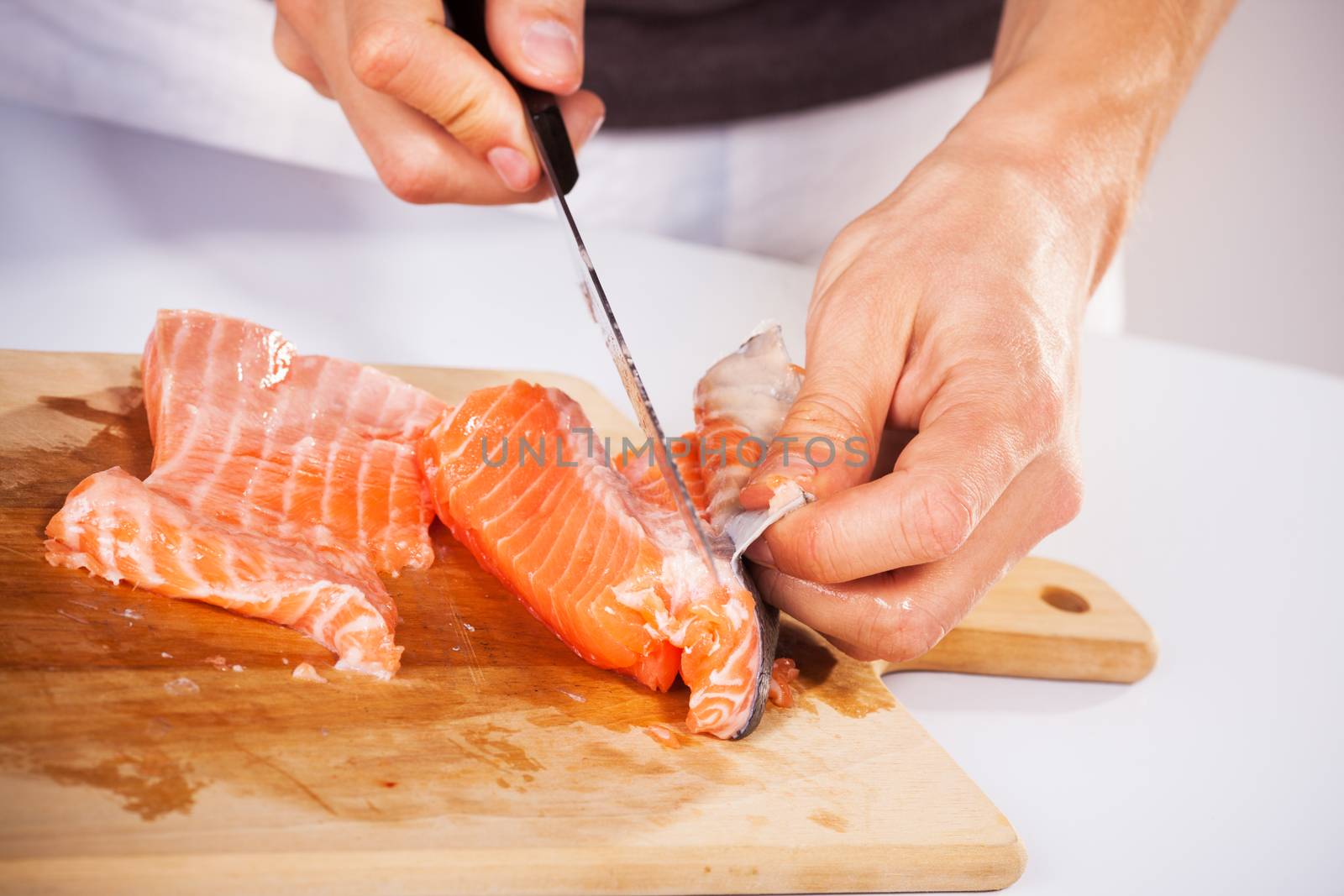 Preparing salmon in the cutting board.