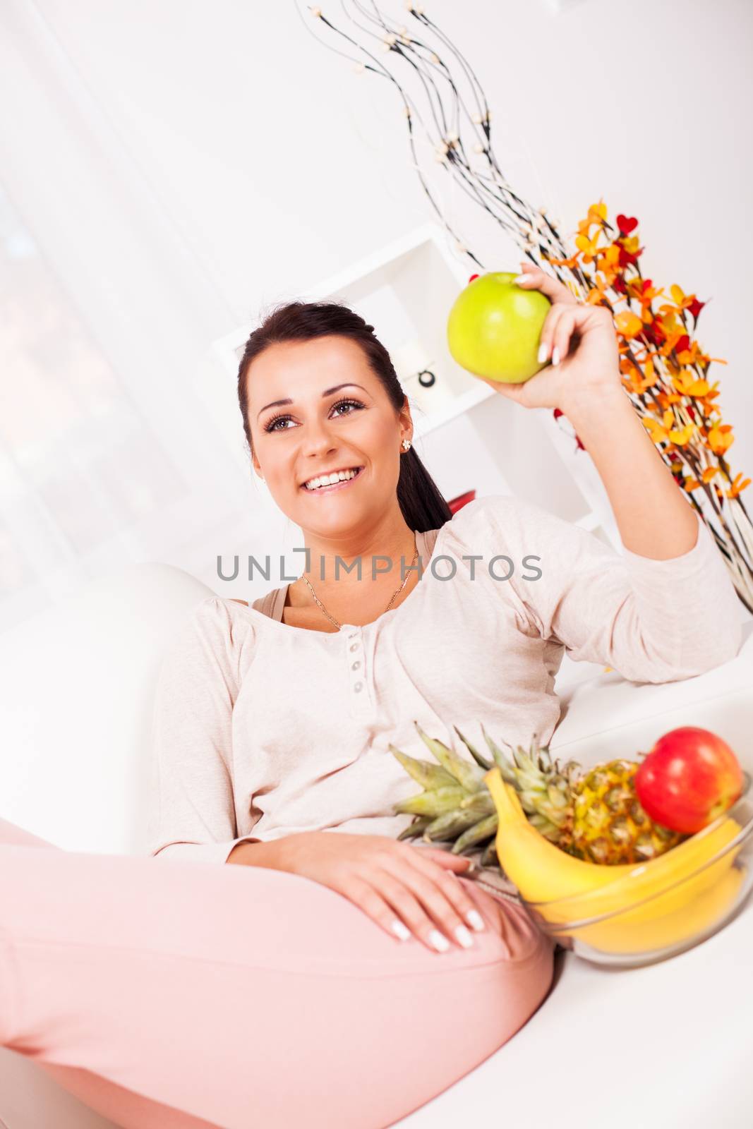 Beautiful young woman with fruits.