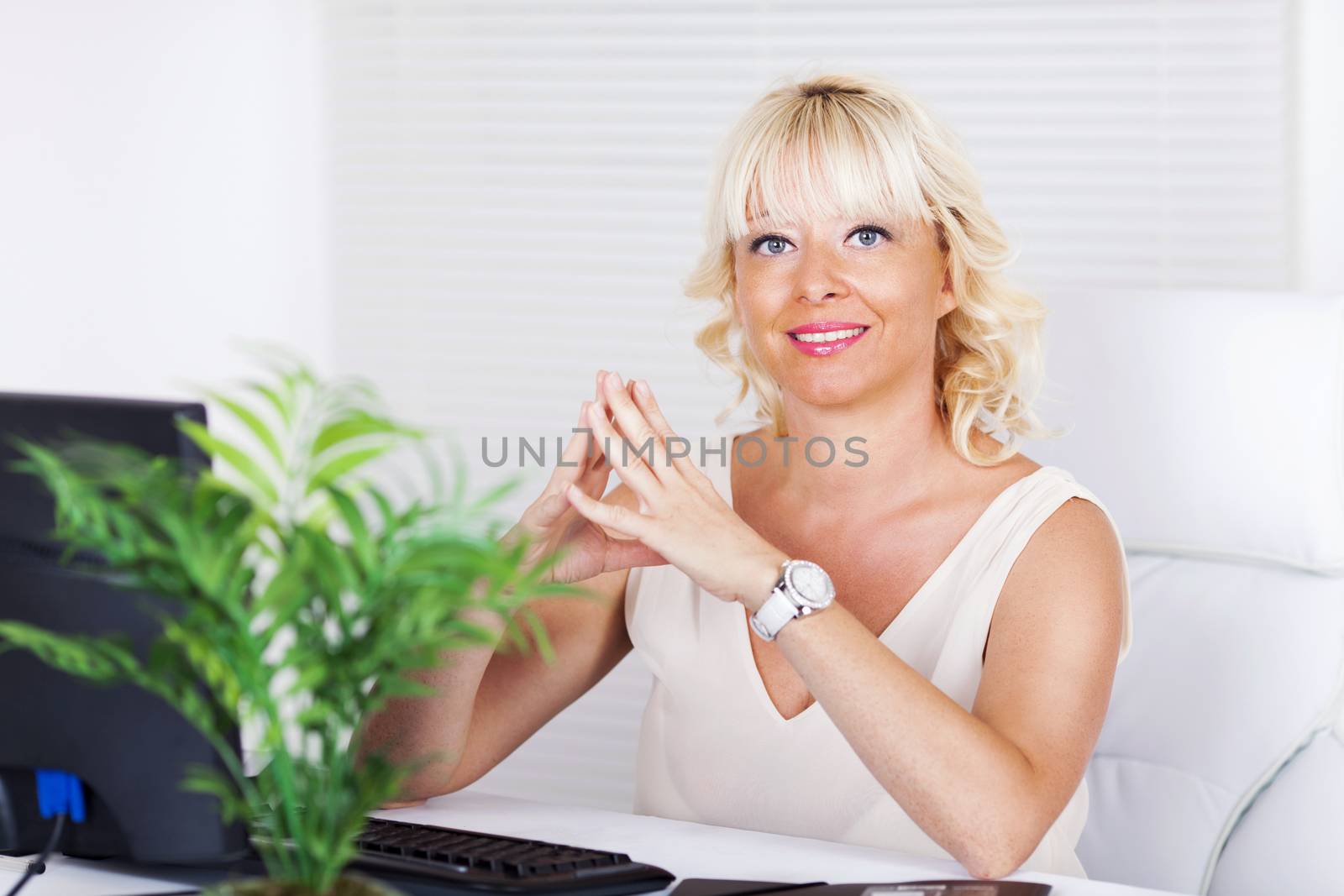 Beautiful mature Business woman sitting in the office.