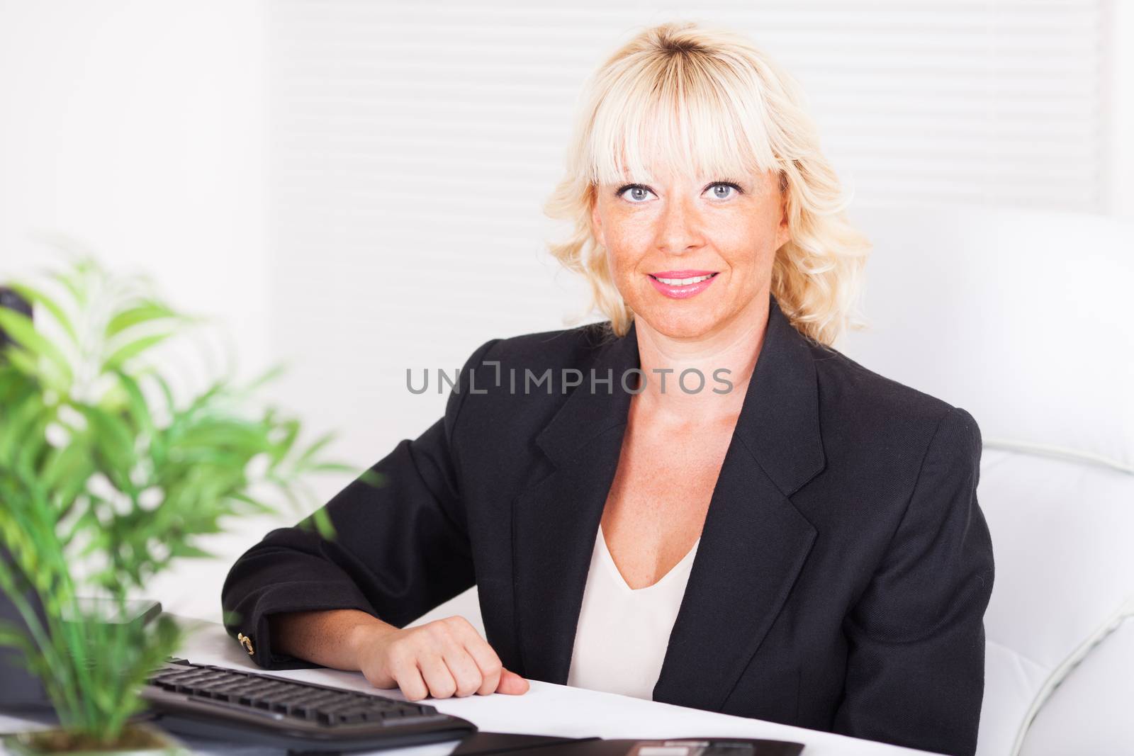 Beautiful mature Business woman sitting in the office.