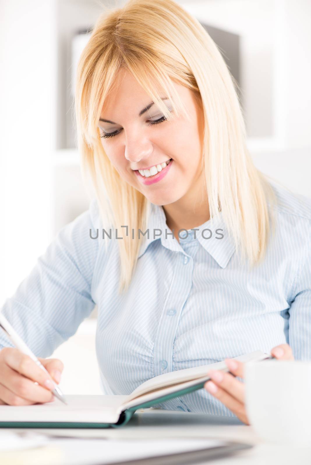 Businesswoman sitting at the table and working in the office.