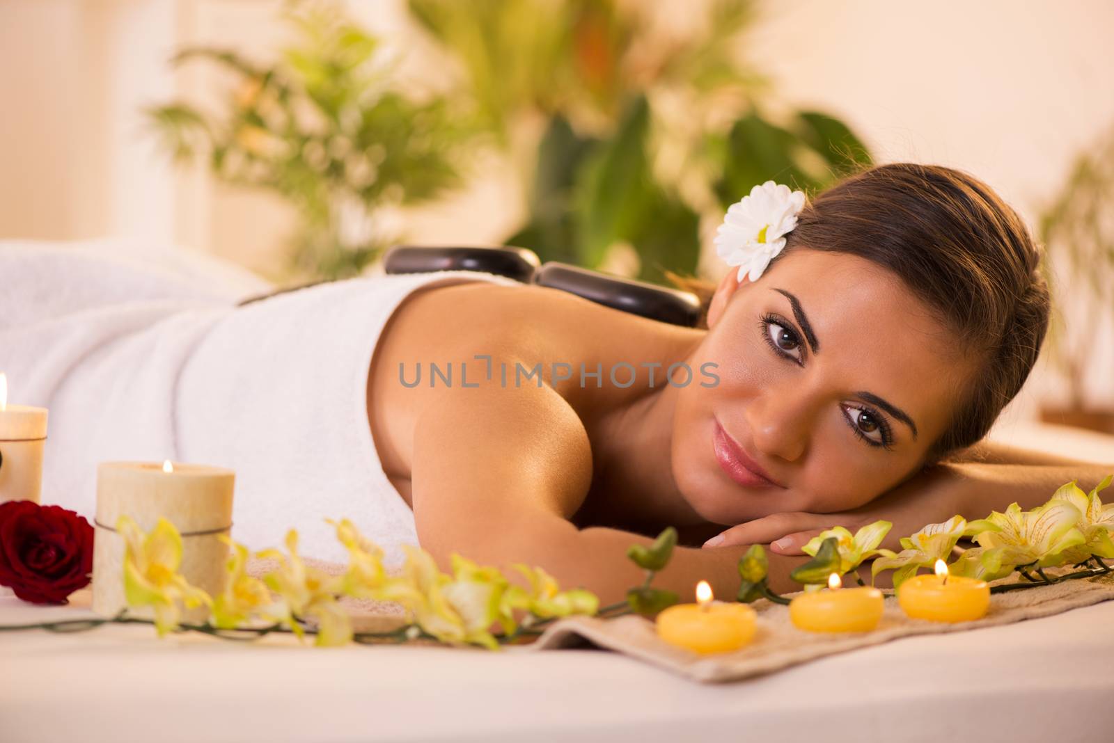 Young beautiful woman relaxing and enjoying at the spa center.