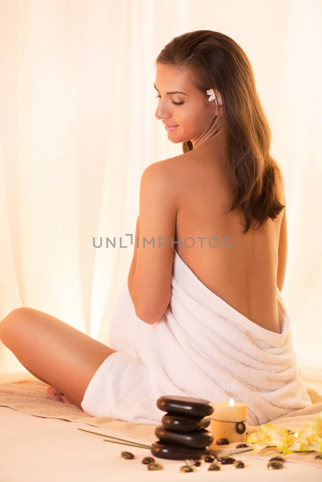 Young beautiful woman with perfect body relaxing and enjoying at the spa center.