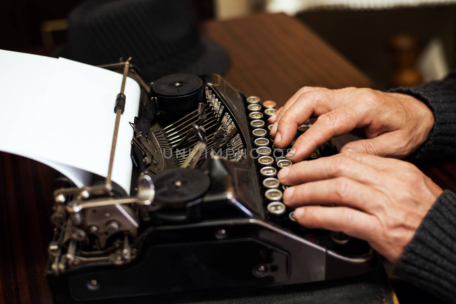 Senior man hands typing on Obsolete Typewriter.
