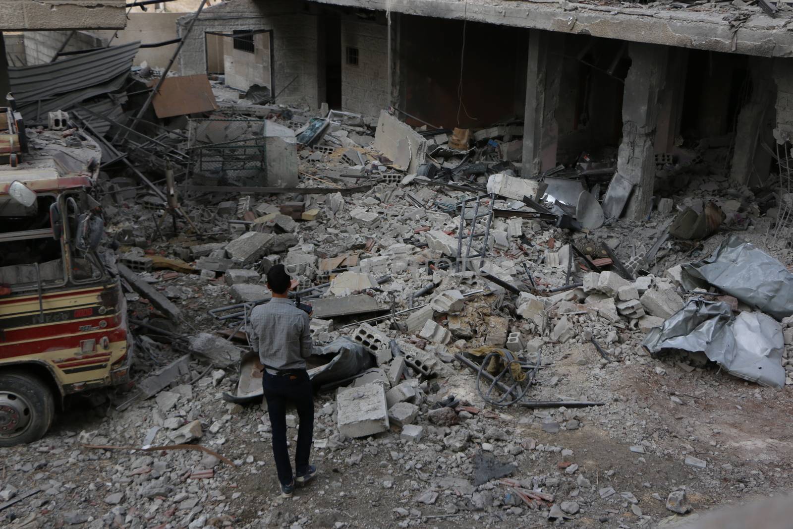 SYRIA, Damascus: A Syrian man looks at damaged buildings in the Marj al-Sultan neighborhood in eastern Damascus on October 24, 2015.