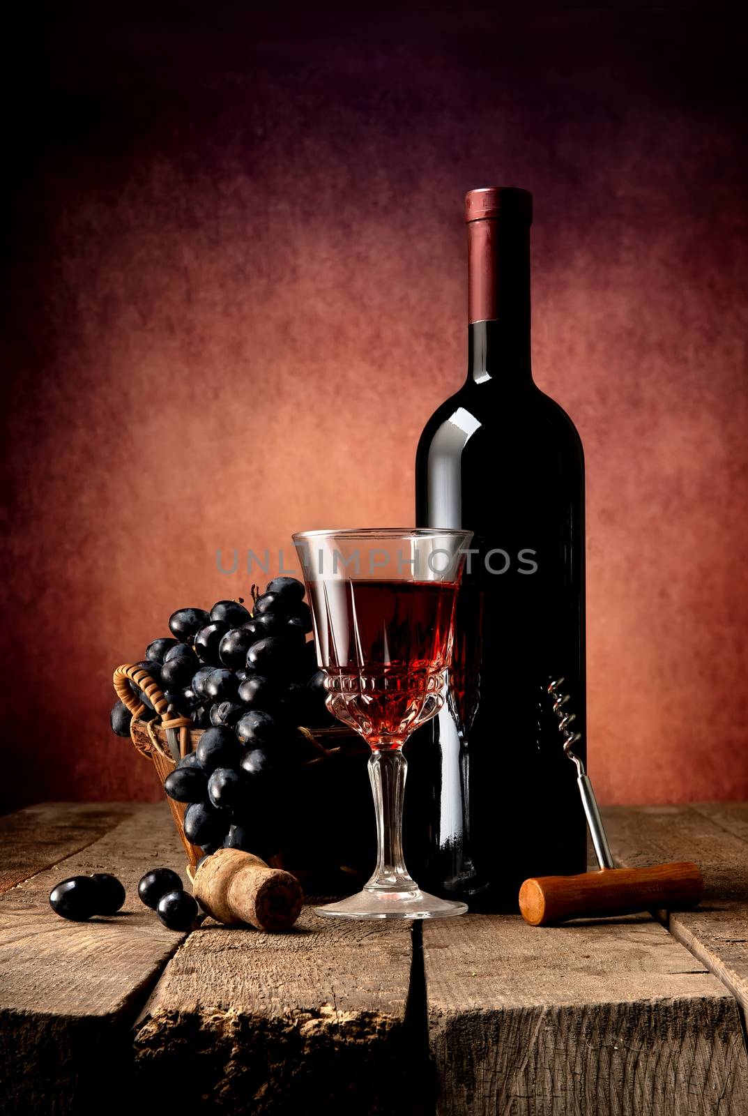 Composition with wine and grape on wooden table