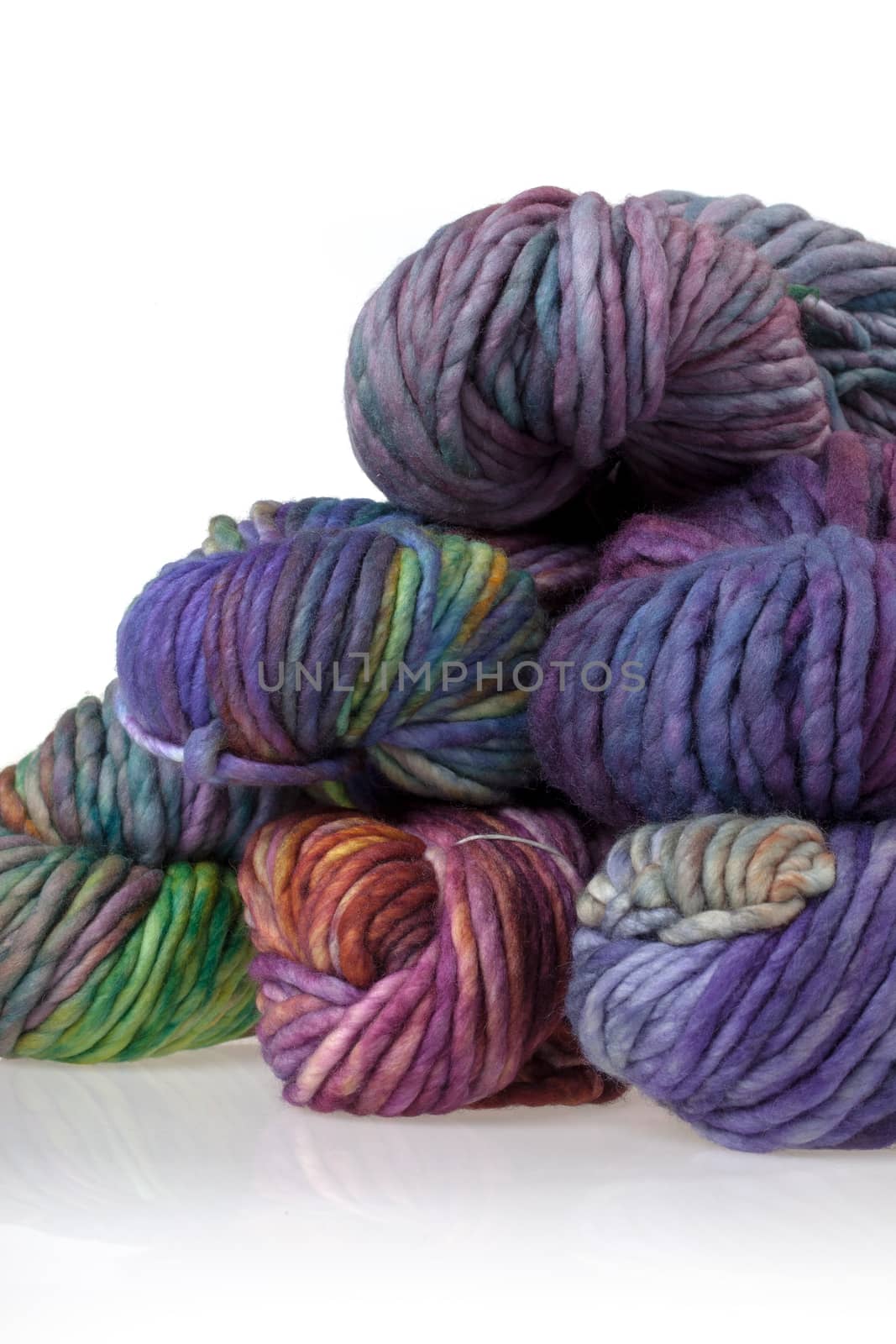 Set of colorful wool yarn balls. Hanks are set out in a pile.