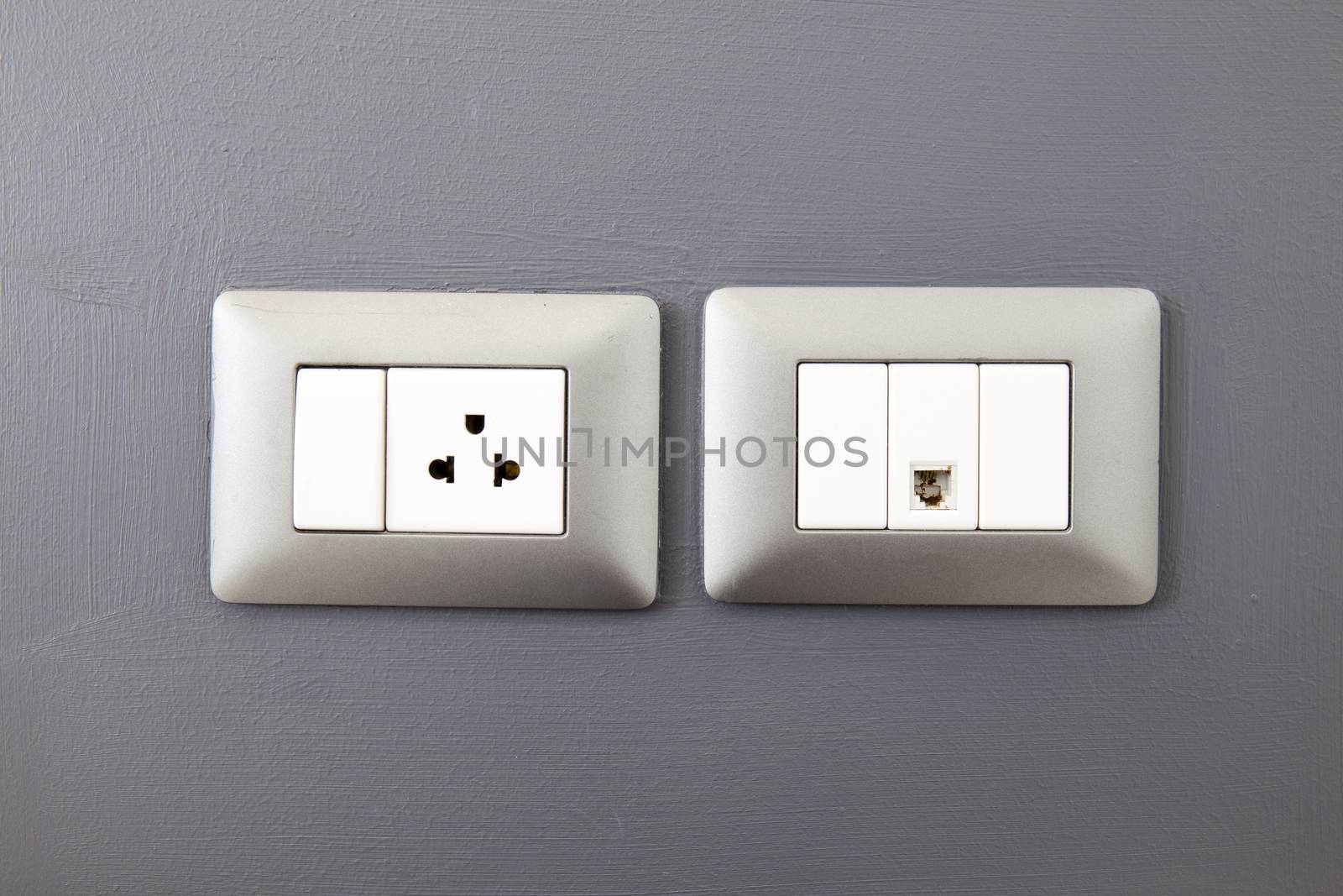 electric plug and network ethernet port on wall by powerbeephoto