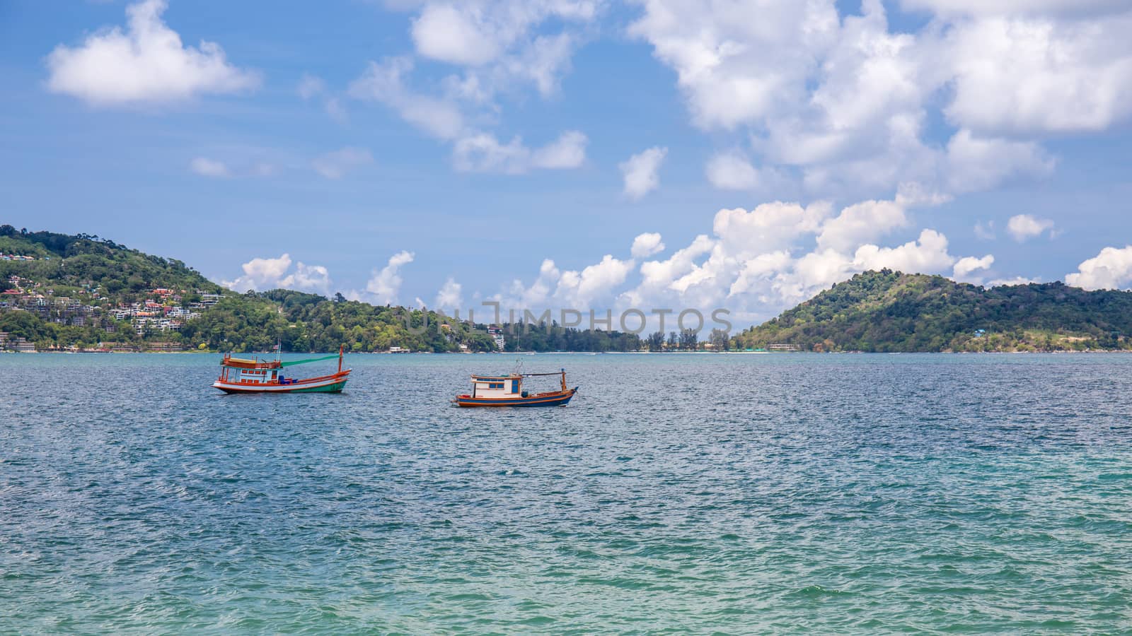 Small fishing boats near the island of Phuket sea. Thailand by powerbeephoto
