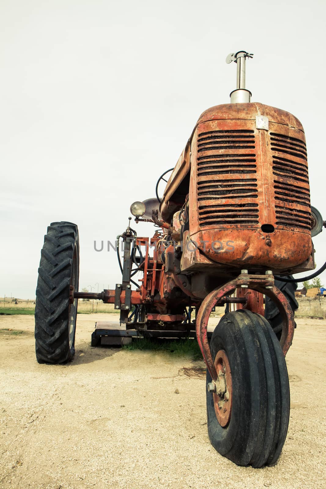 Image of an old time tractor that has been slightly faded