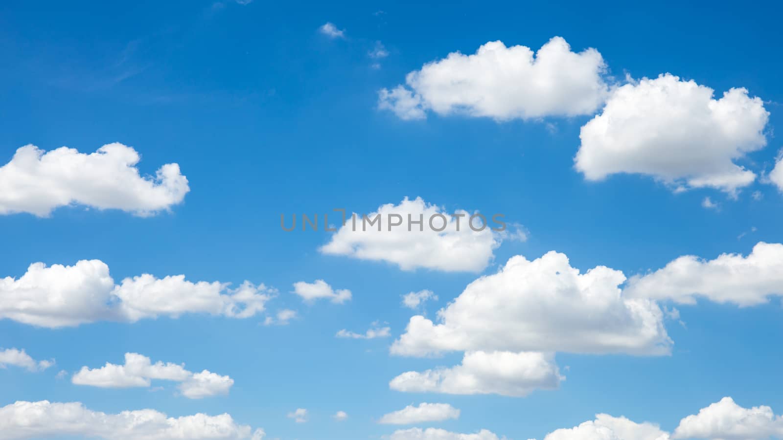 blue sky background with wave clouds by powerbeephoto
