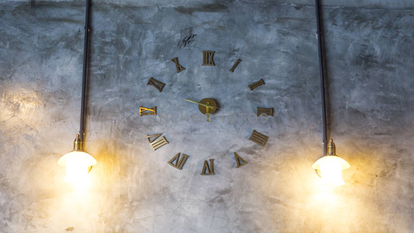 Cement wall with vintage clock and light bulbs