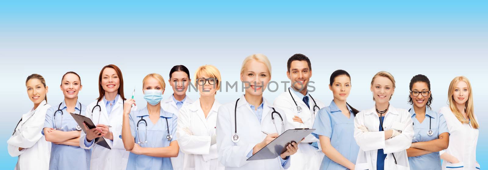 smiling female doctors and nurses with stethoscope by dolgachov