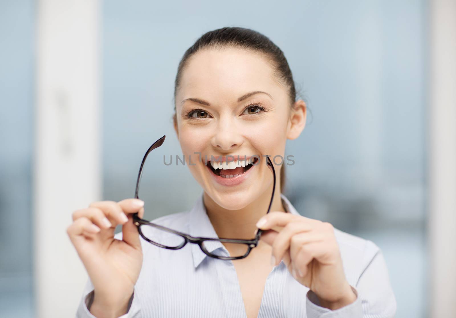 business and education concept - laughing businesswoman with eyeglasses