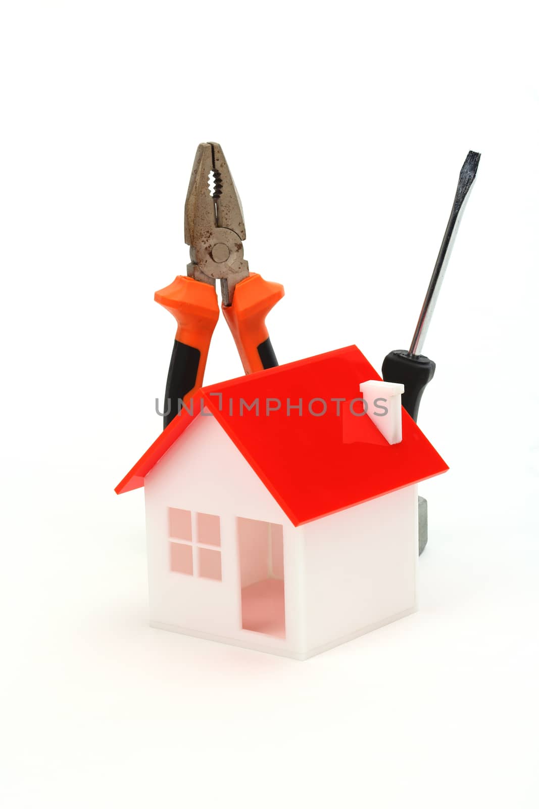 model of house and tools over white