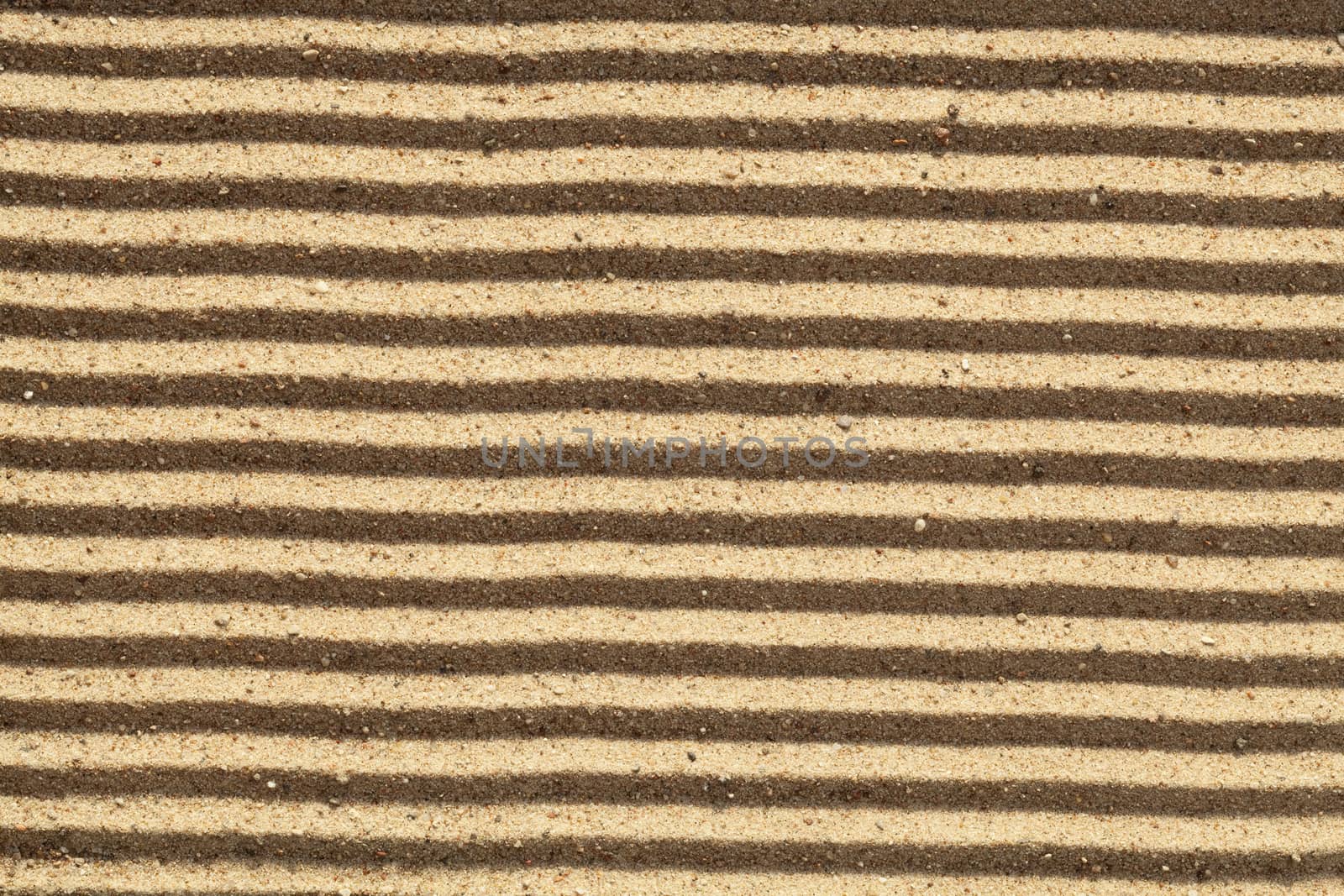 yellow dry sand in stripes as background