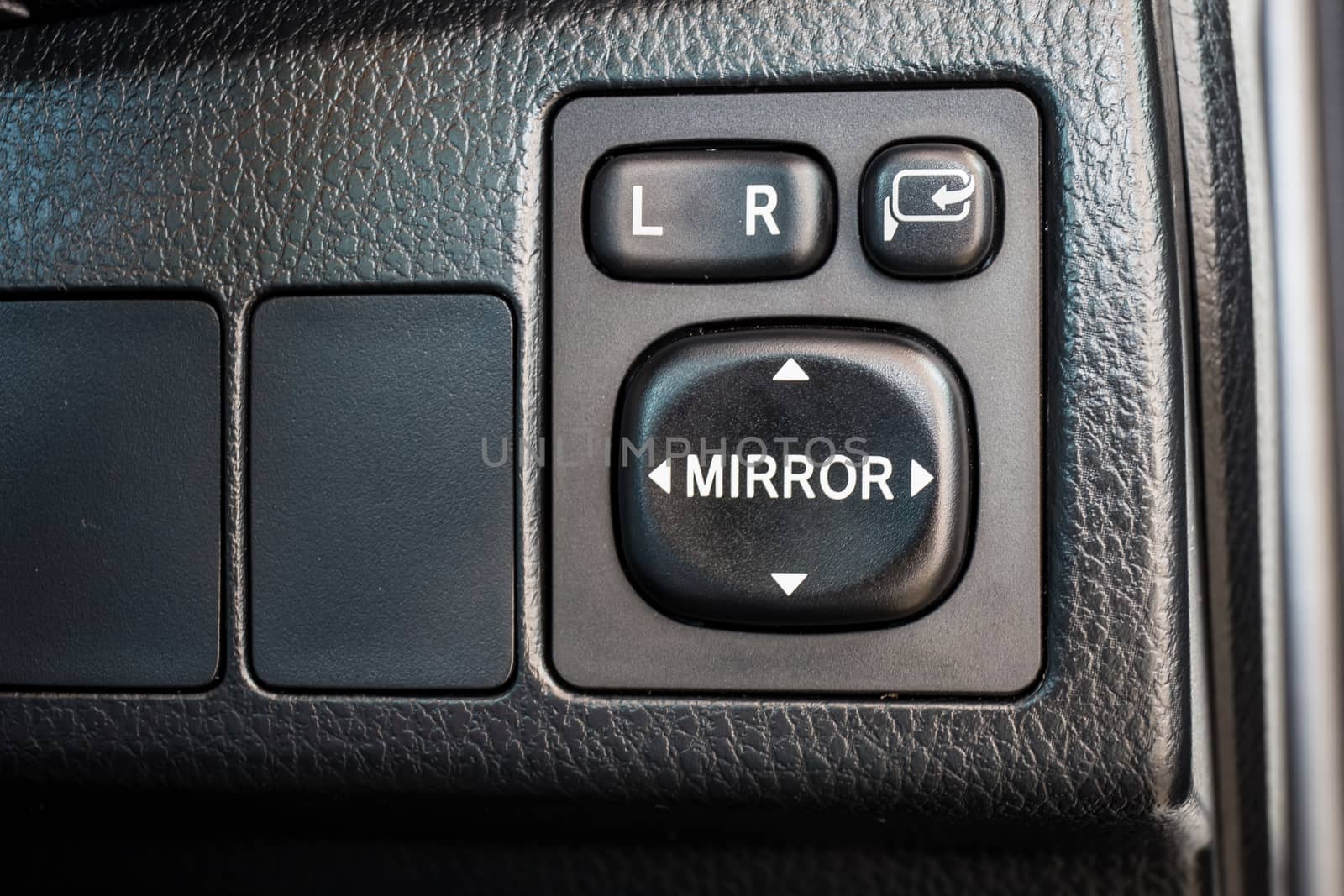 Switch button adjust or controls side mirrors in a car by powerbeephoto