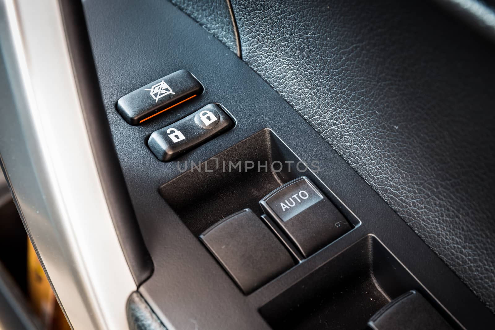 Car window control and adjustment buttons. Focus lock and unlock button by powerbeephoto