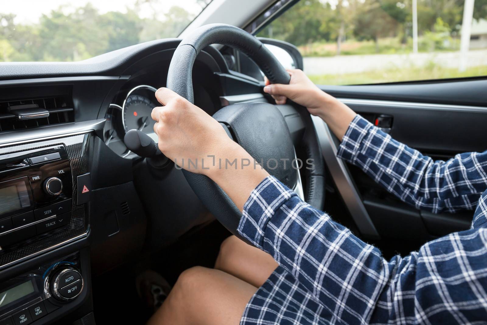 woman driving a car by powerbeephoto