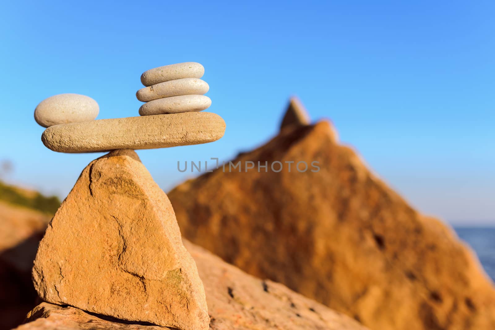 Balanced stack of pebbles on the stony seashore