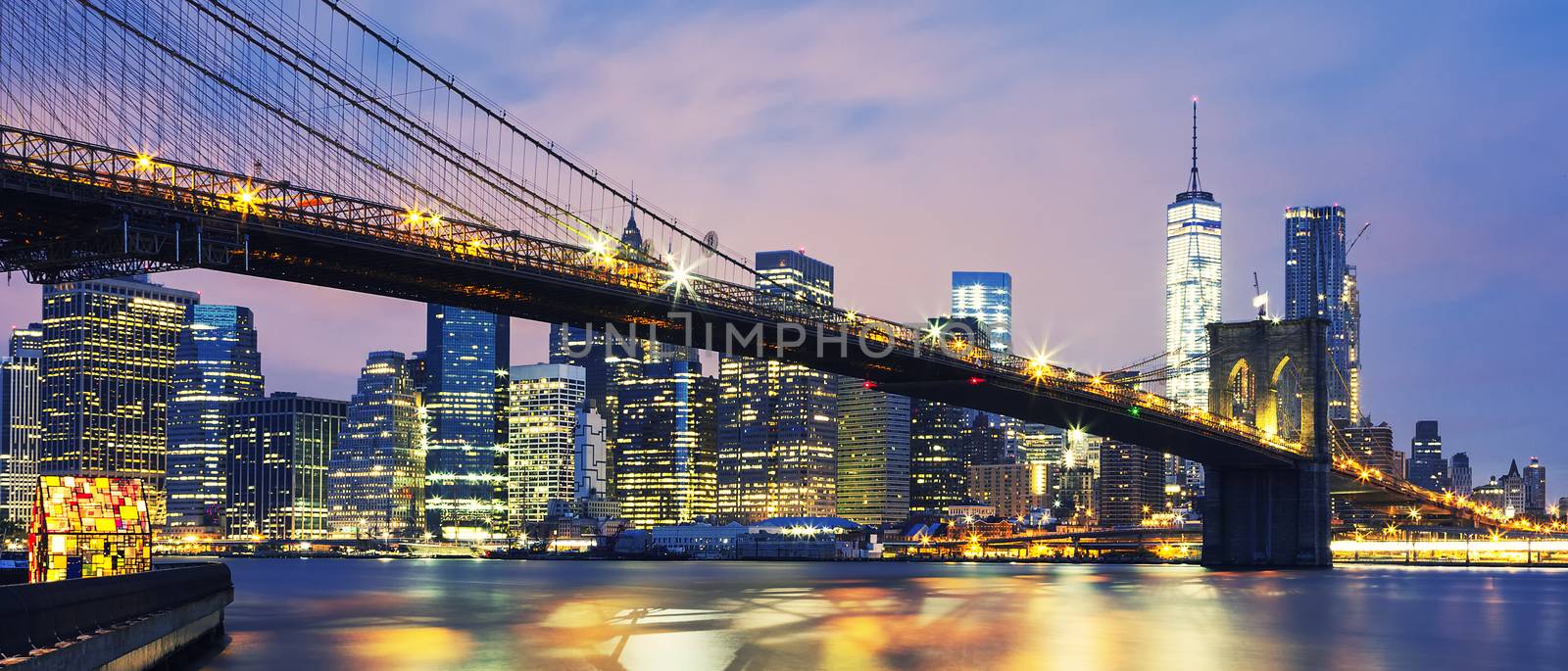 Panoramic view of New York City Manhattan midtown at dusk with Brooklyn Bridge