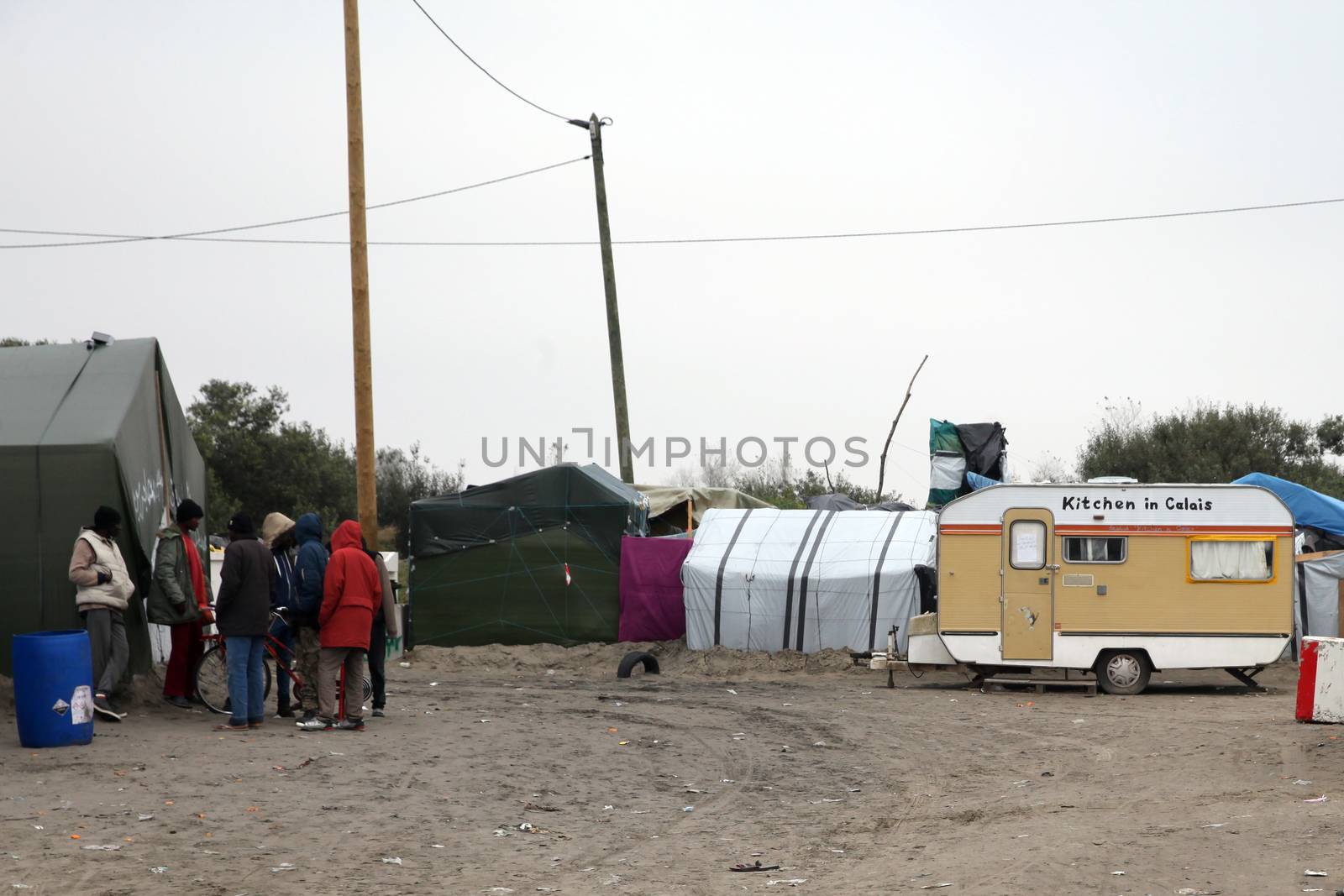 FRANCE, Calais: Migrants talk outside of tents in the New Jungle migrant camp, in Calais, northern France, where around 6.000 migrants live in the hope of crossing the Channel to Britain, on October 26, 2015.
