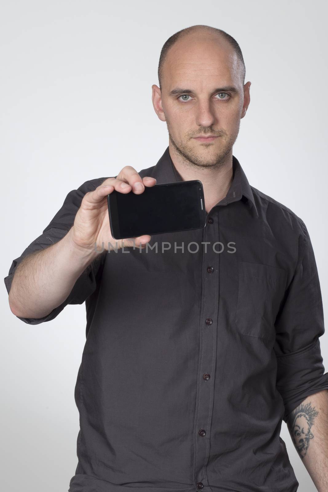 Standing man showing front of phone by mattkusb