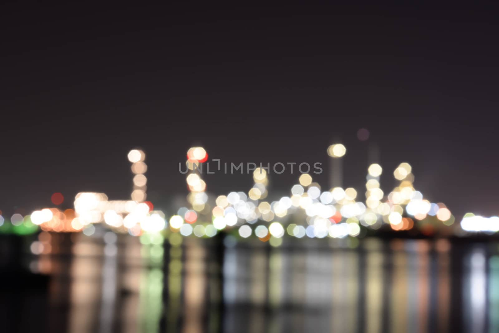 Blurred Light of oil refinery reflecting on the surface