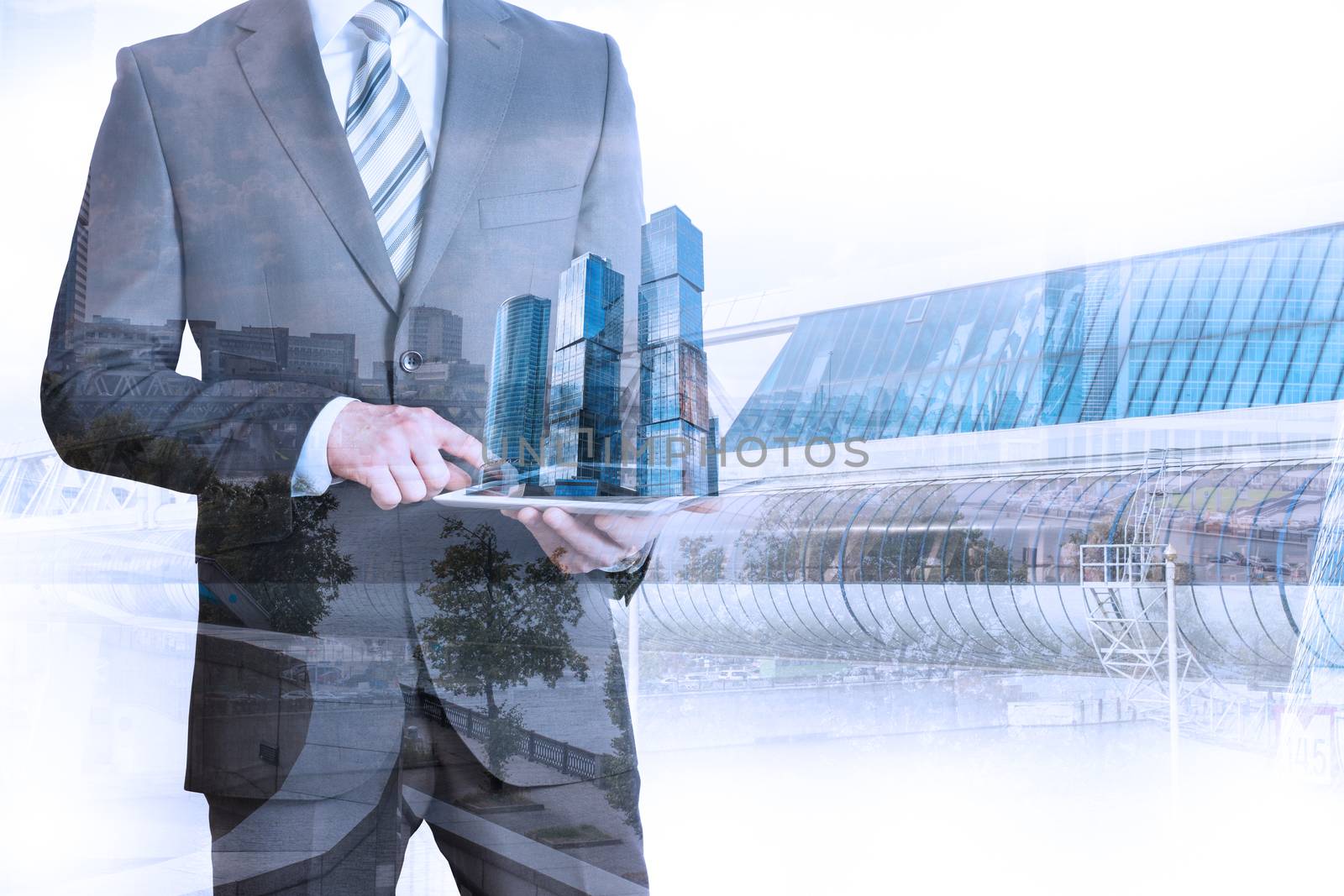 Businessman holding tablet with 3d city model on cityscape background