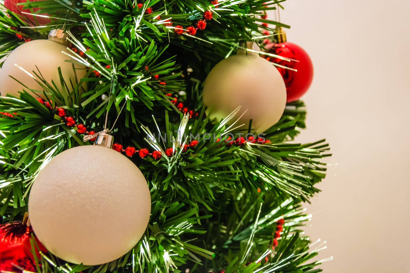 Close up of a decorated christmas tree with white and red balls