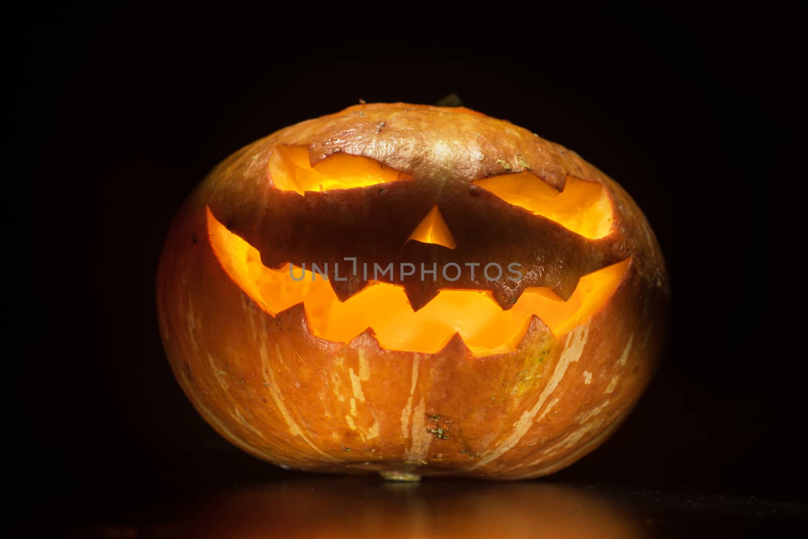 Halloween pumpkin with scary face on black backgound