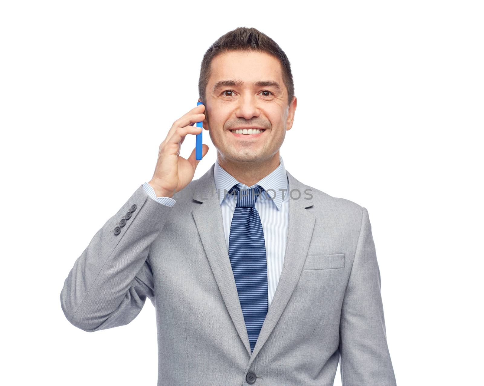 happy businessman calling on smartphone by dolgachov