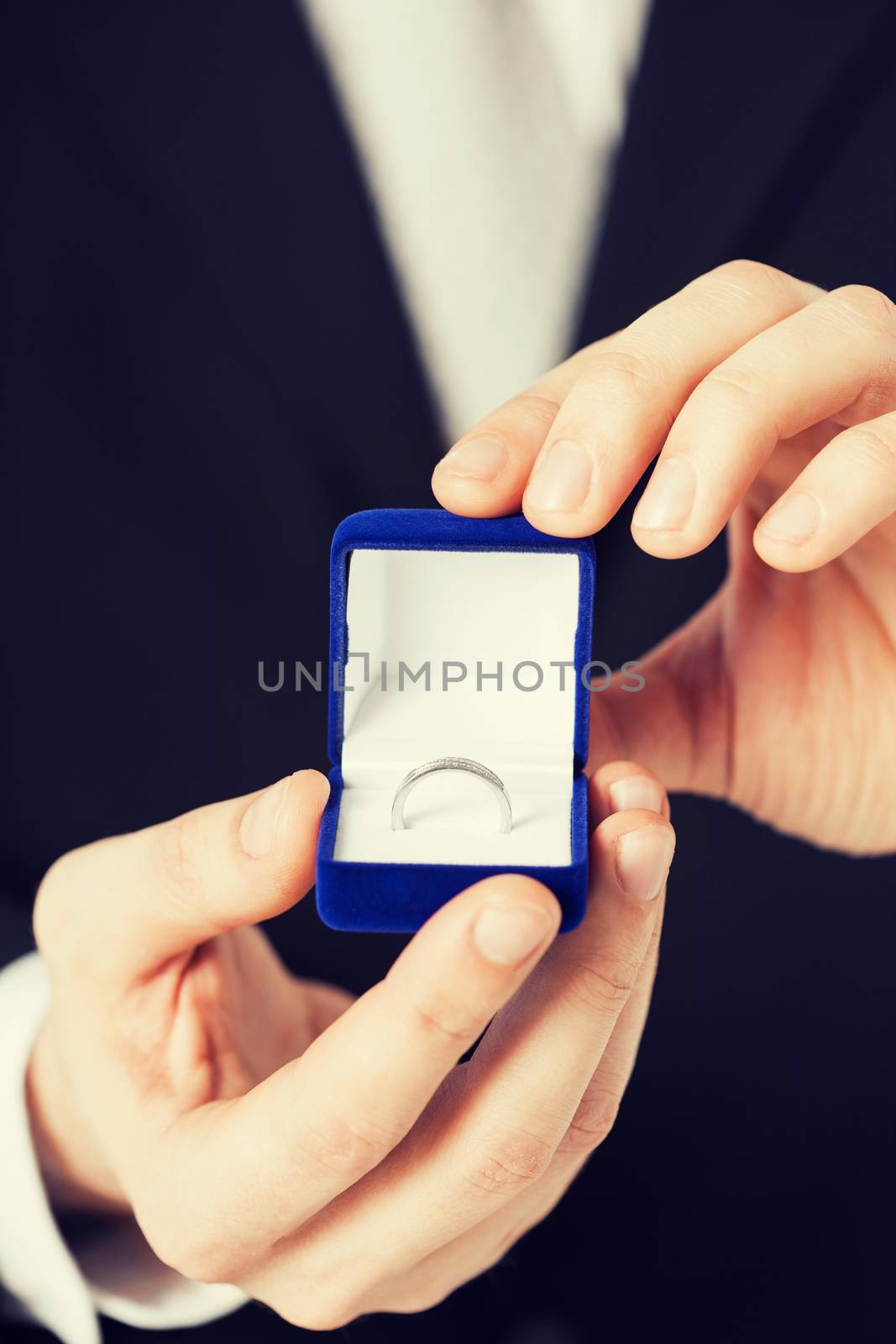 man with gift box and wedding ring by dolgachov