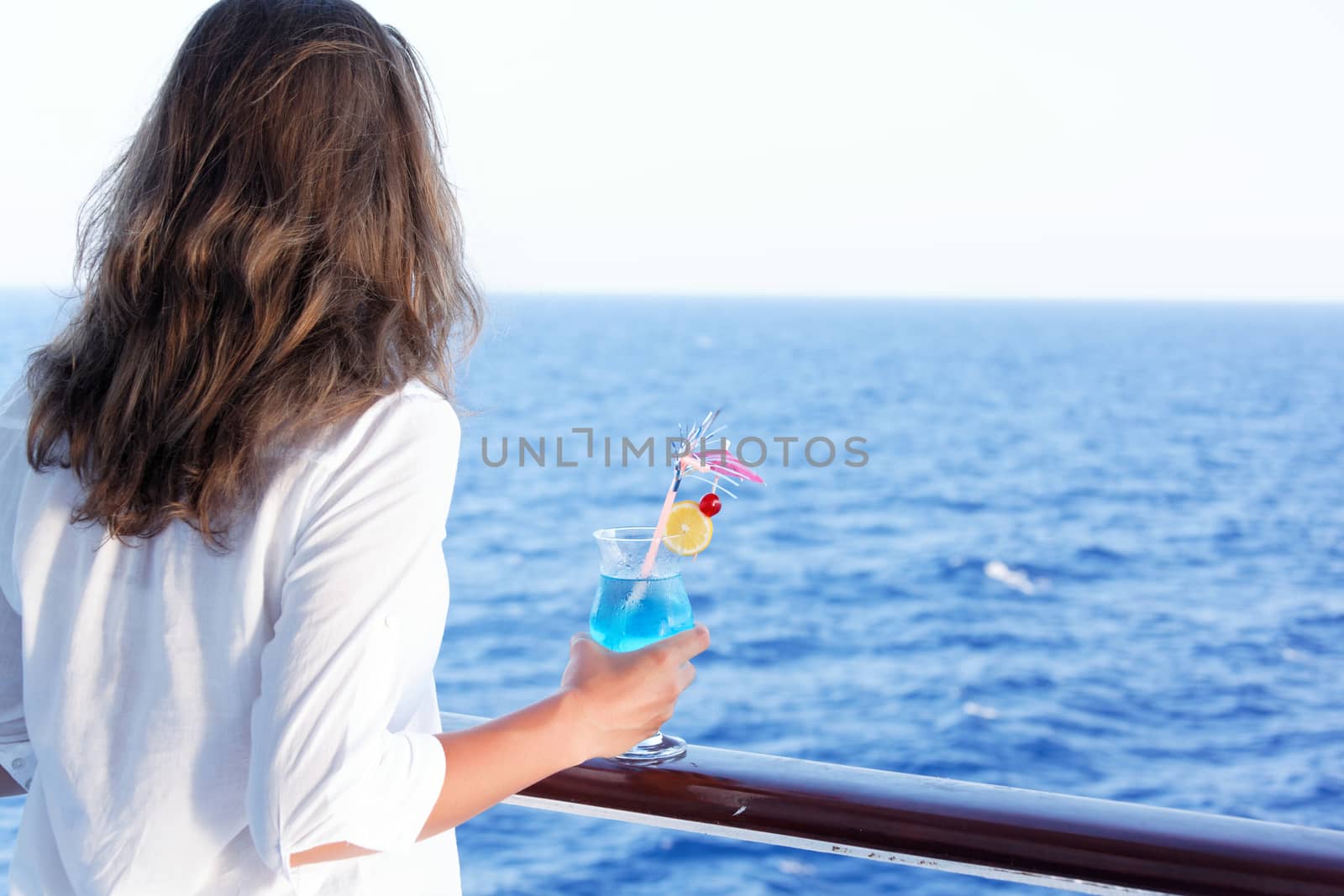 pretty girl enjoys traveling on a ship at sea