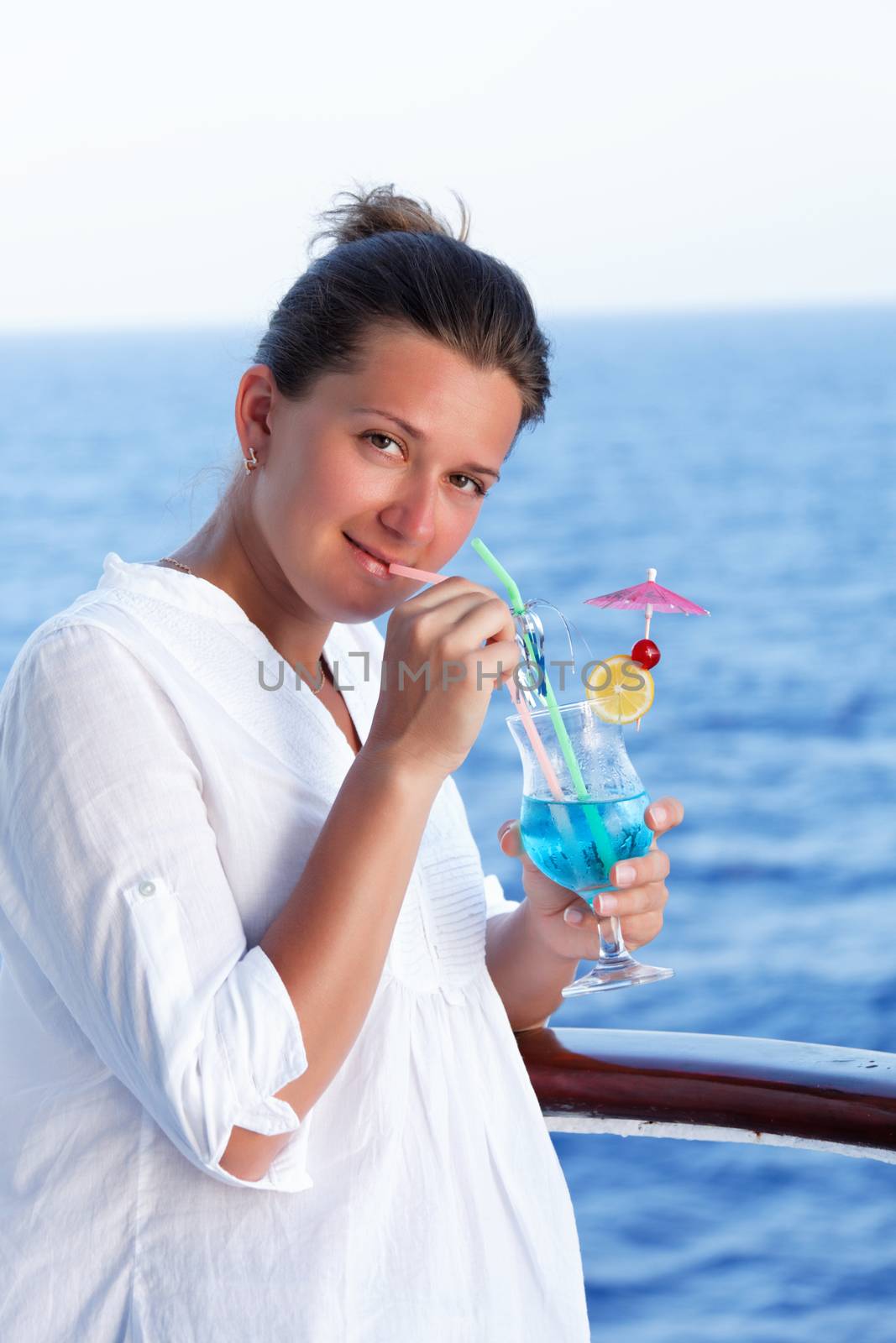 cute brunette girl enjoys traveling on a ship at sea