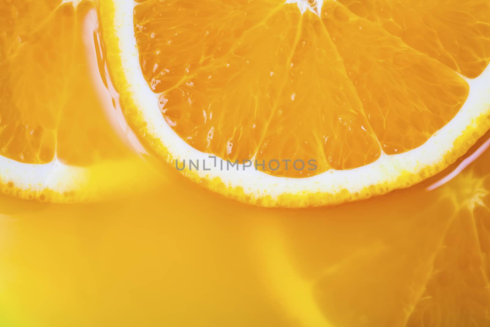 fresh a slice of orange close-up on yellow background